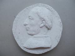 Tirage d'une médaille : buste d'homme de profil gauche