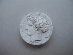 Tirage d'une monnaie : tête de profil gauche