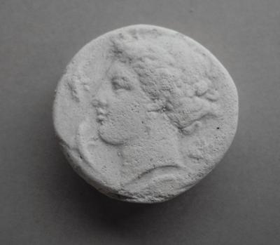 Tirage d'une monnaie : tête de profil gauche.